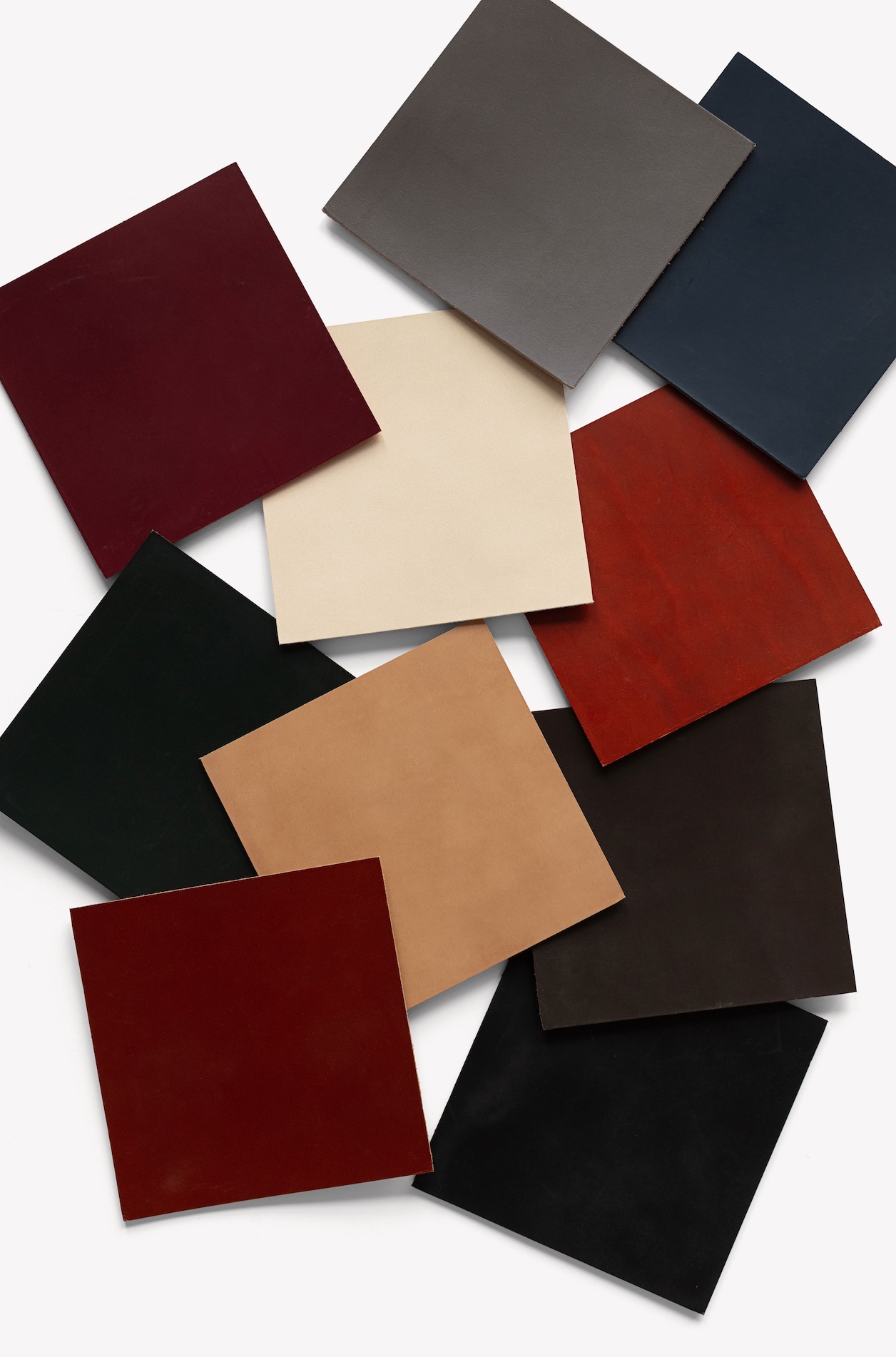 Ten samples of leather tiles, shown overlapping each other